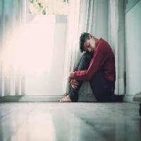 depression-200-200 Man with depression sitting alone in corner